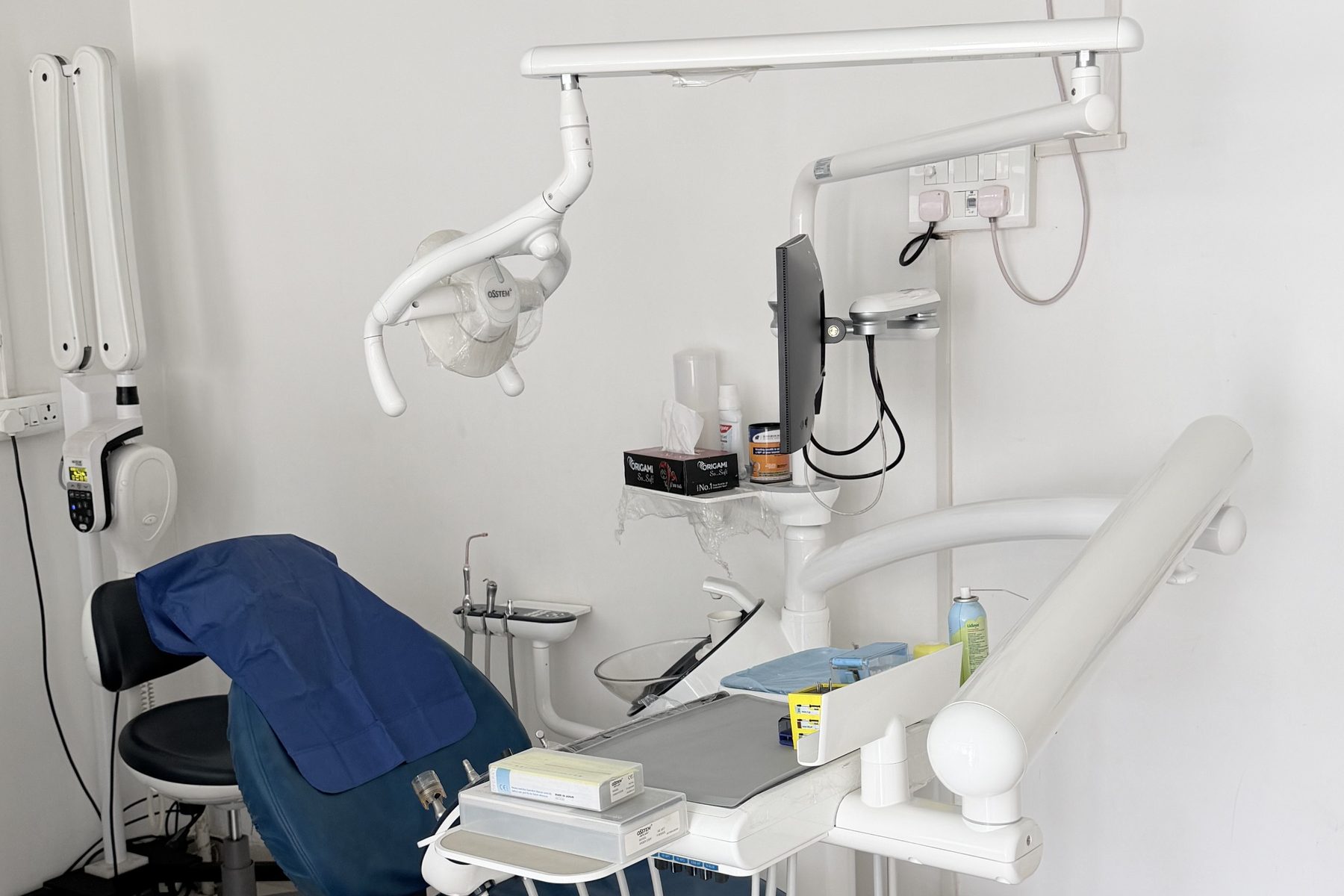 The dental chair and instrument console in the clinic treatment room.